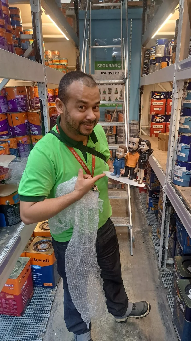 Cliente sorrindo com boneco 3D personalizado em homenagem